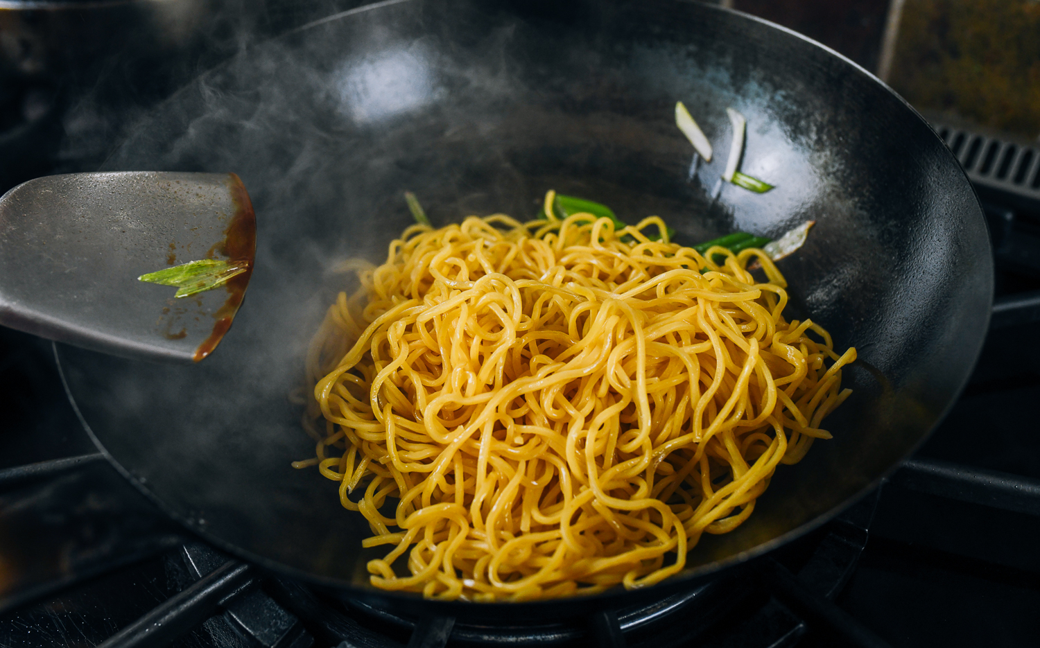 lo mein noodles in wok