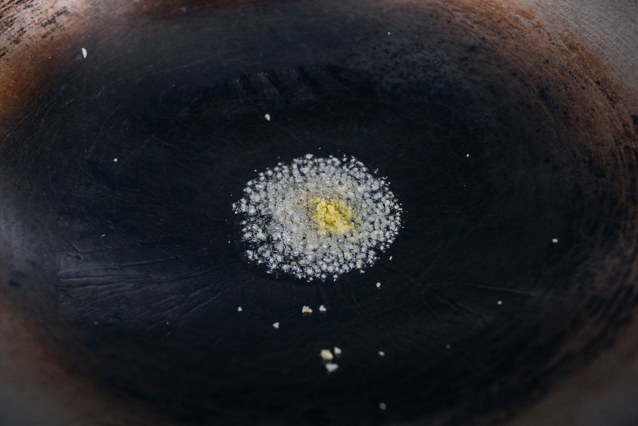 Wok with oil and sizzling ginger