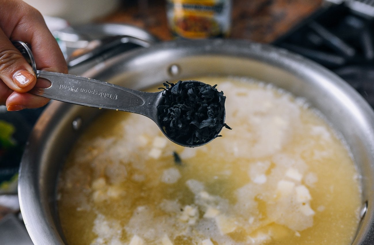adding a tablespoon of dried wakame seaweed to soup pot