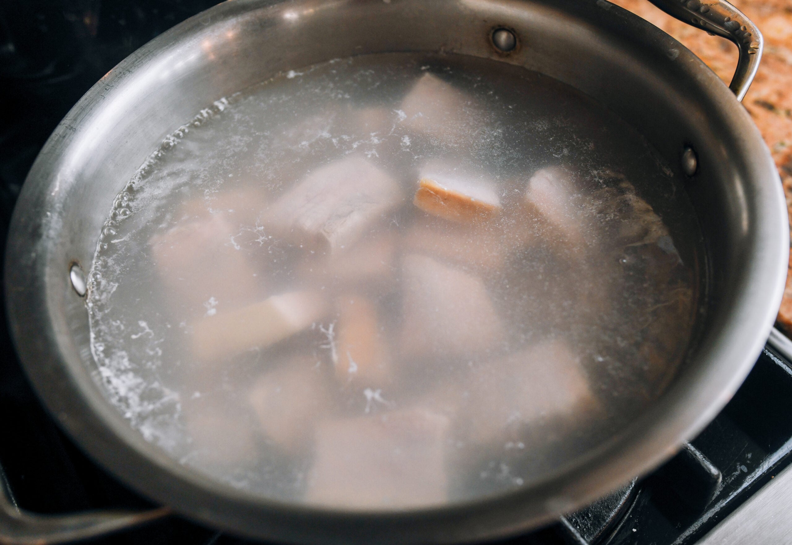 blanching pork belly pieces