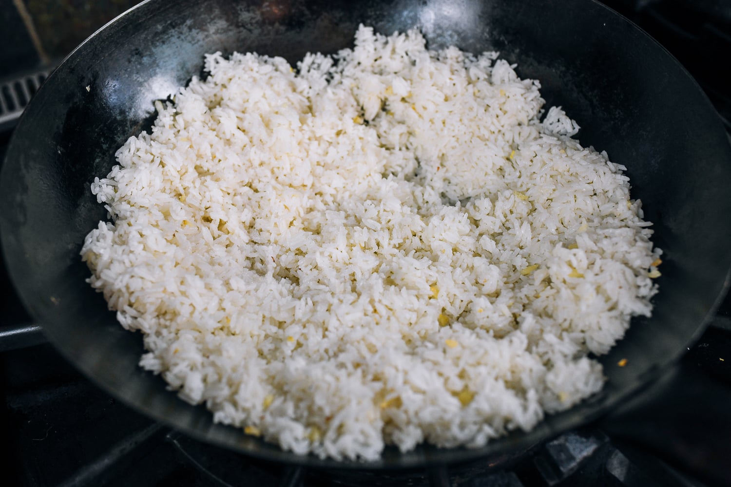rice spread in one layer in wok