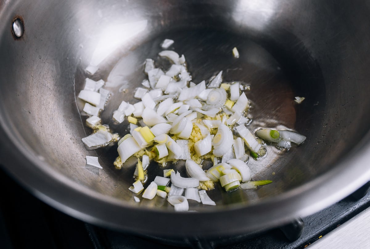 scallion whites, ginger in soup pot