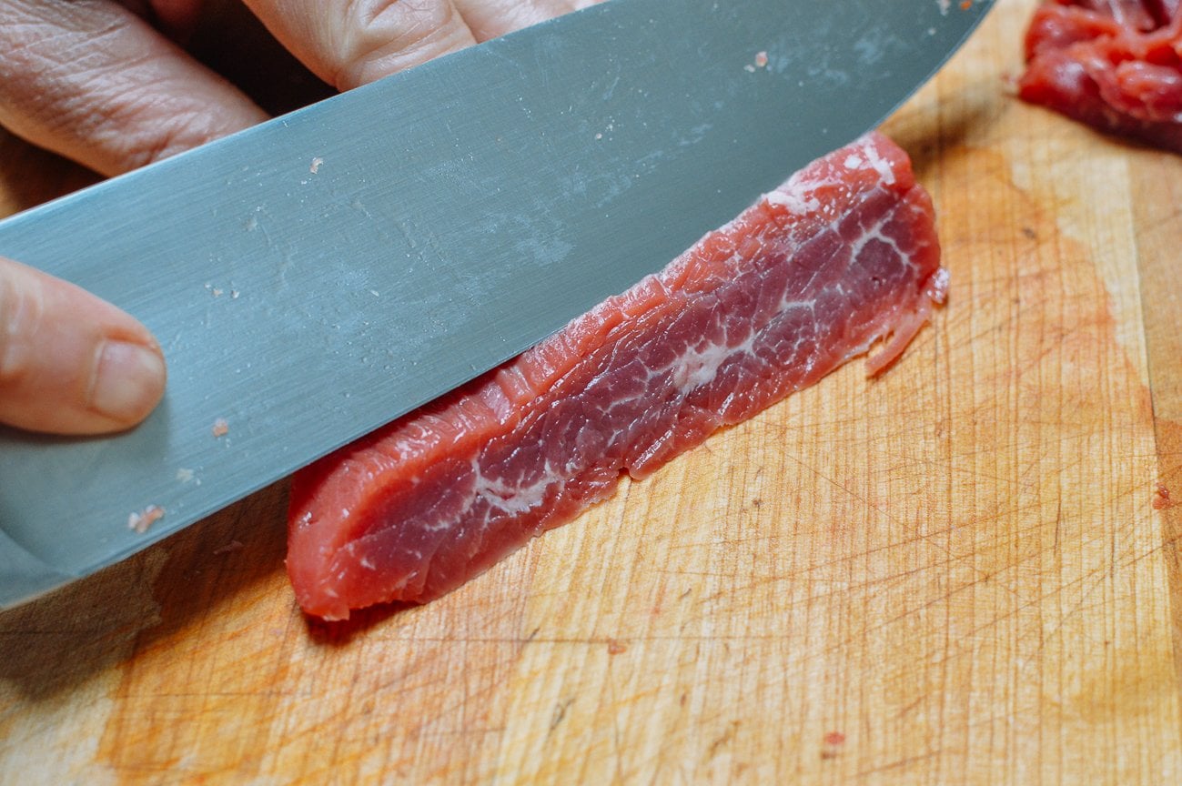 thinly slicing flank steak against the grain