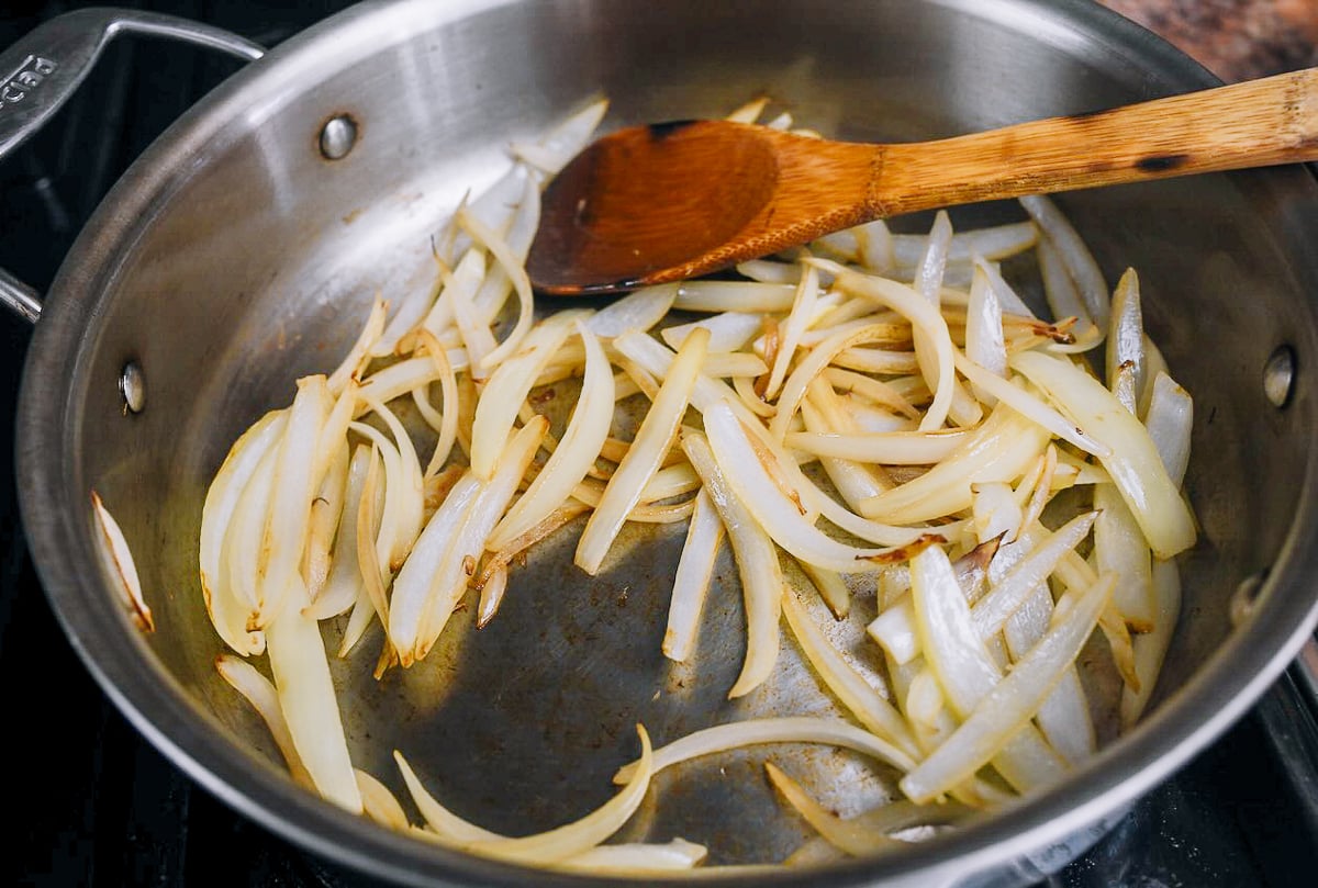 cooking and browning sliced onion in skillet