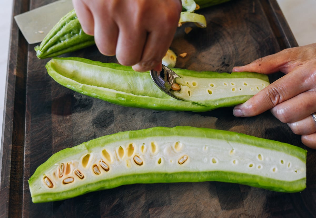 scooping white center out of bitter melon