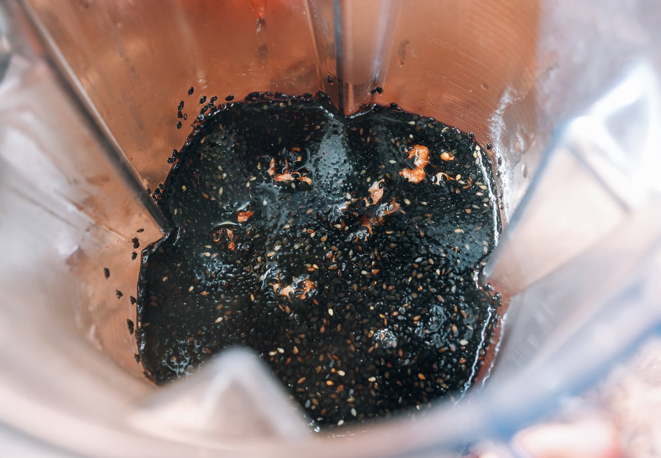 black sesame seeds, water, walnuts, and black rice in blender