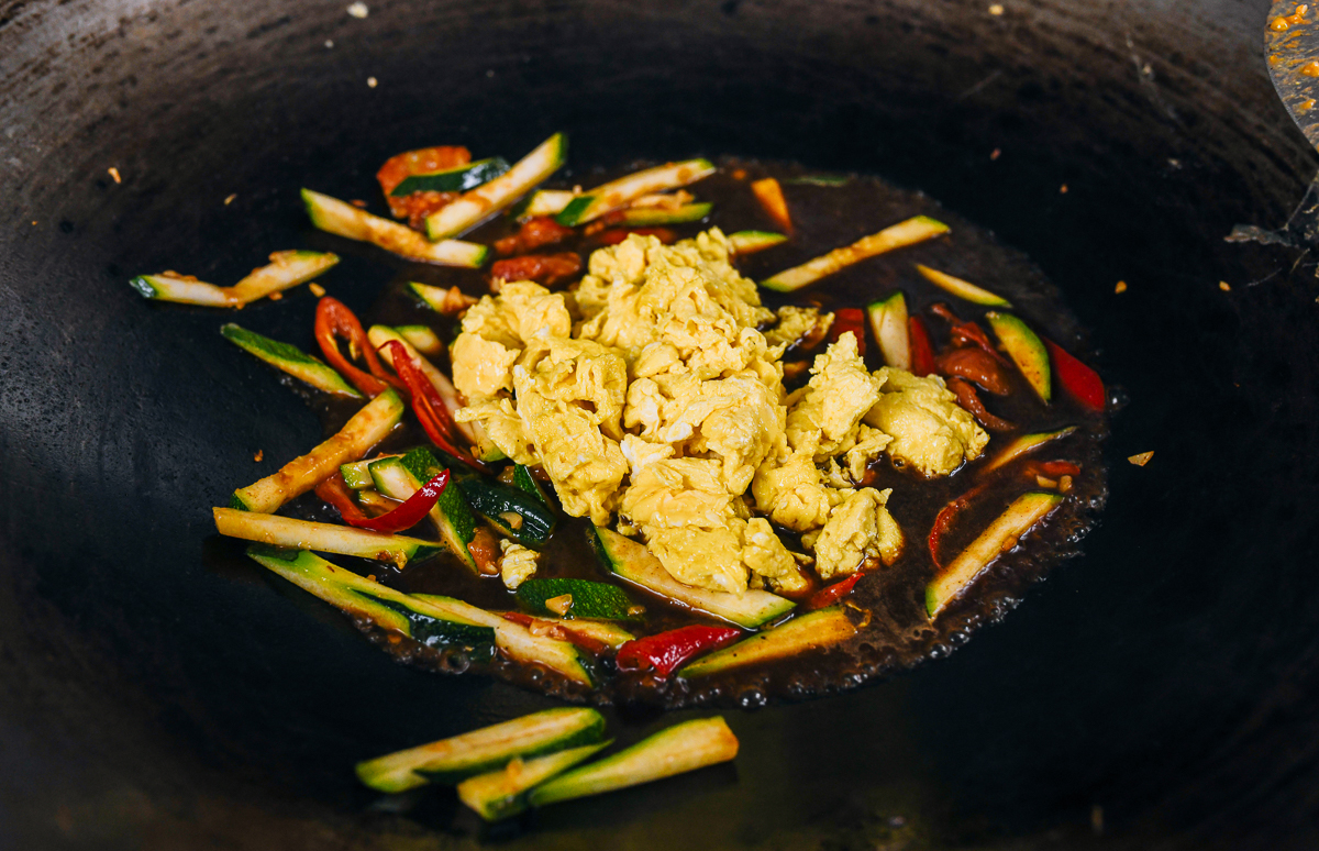 scrambled eggs and vegetables in wok