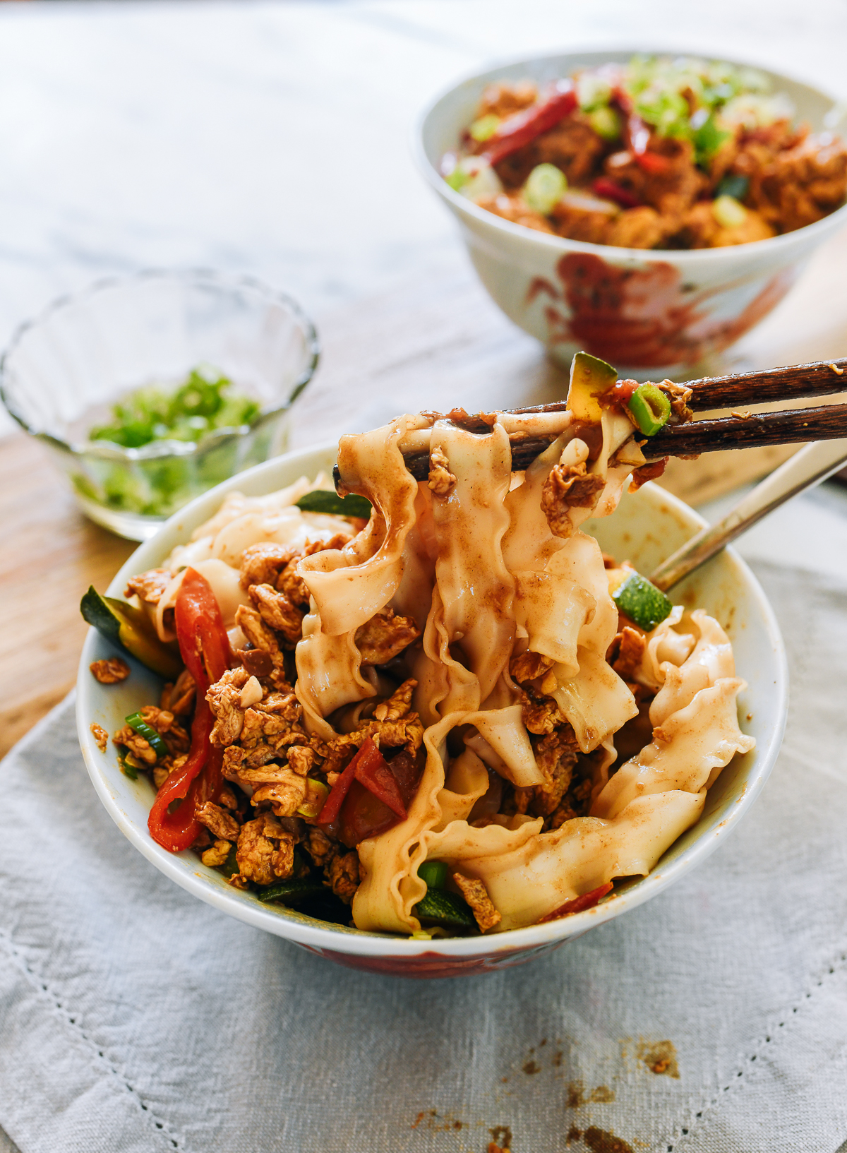 mixing braised egg noodles with chopsticks