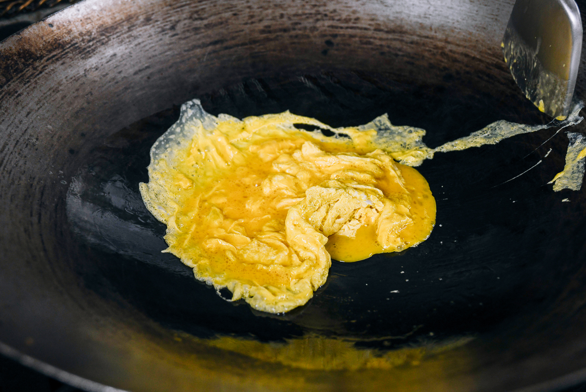 scrambling eggs in a wok