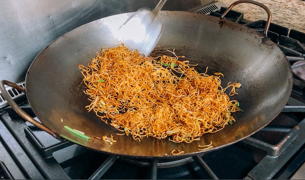 Making hong kong style pan-fried noodles with soy sauce in wok