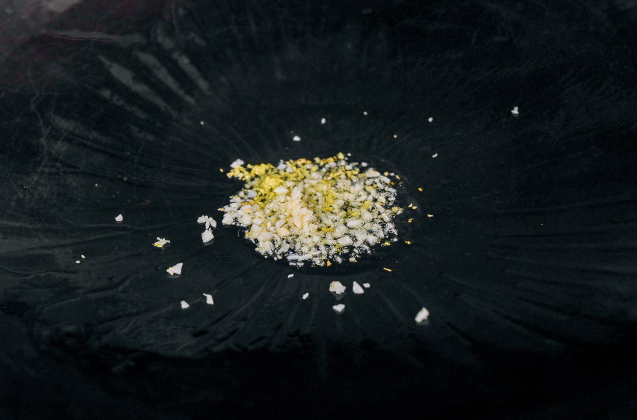 garlic and ginger in wok with oil