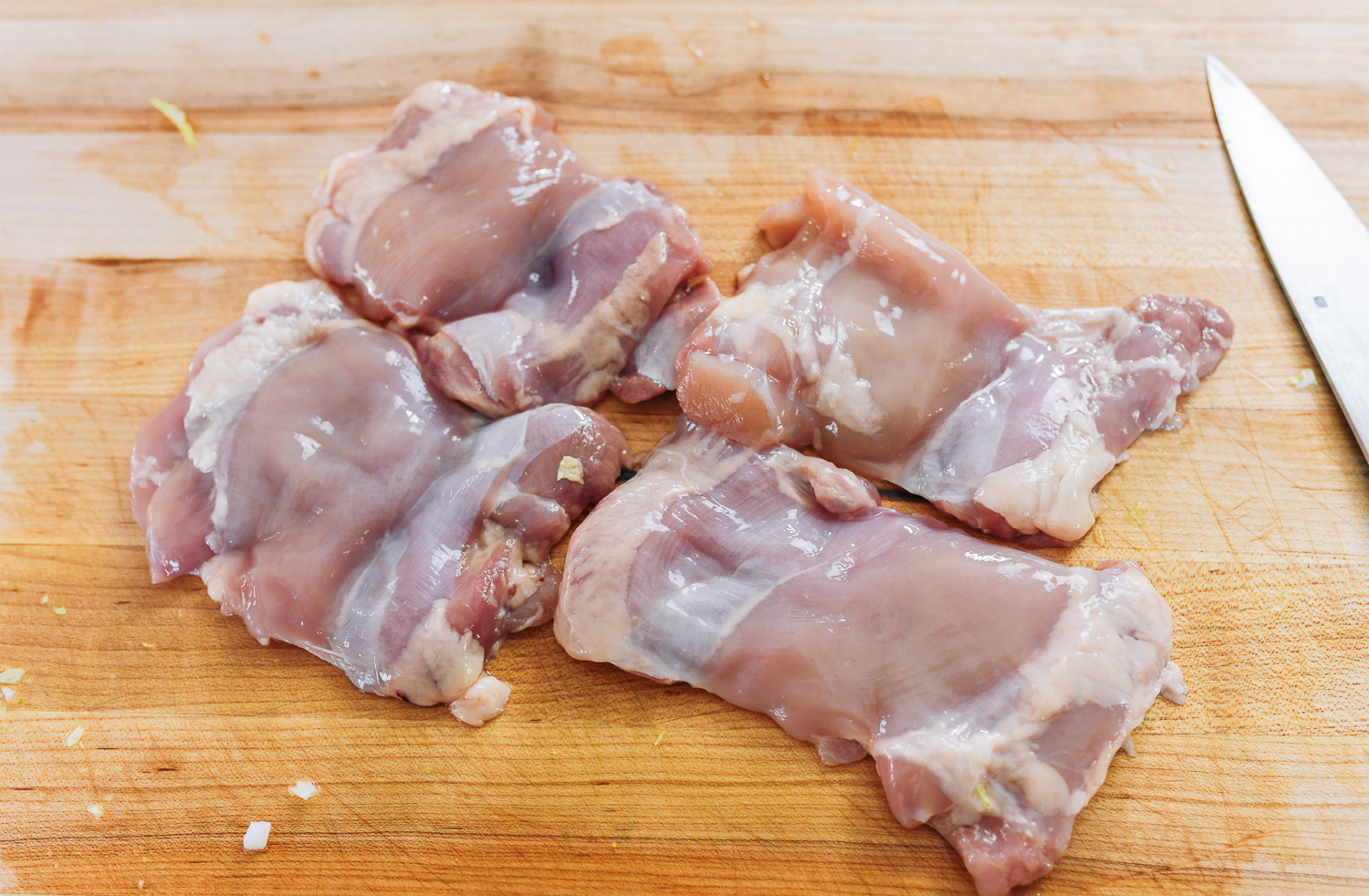 boneless skinless chicken thighs on cutting board