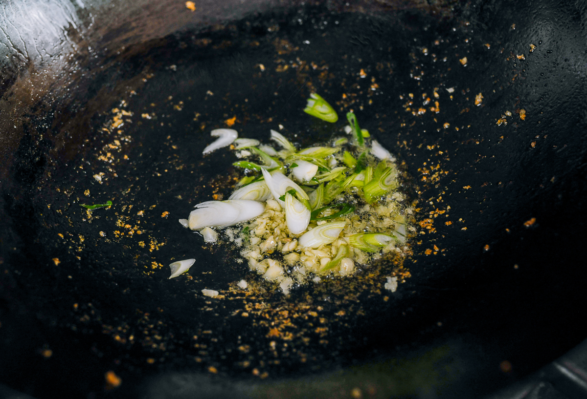 garlic and white parts of scallions in wok
