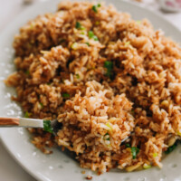 scooping garlic fried rice with a spoon