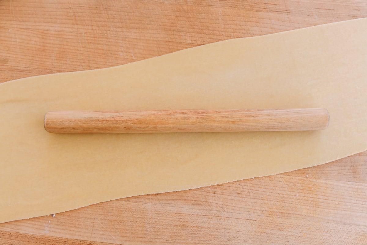 flat dough sheet on wooding cutting board