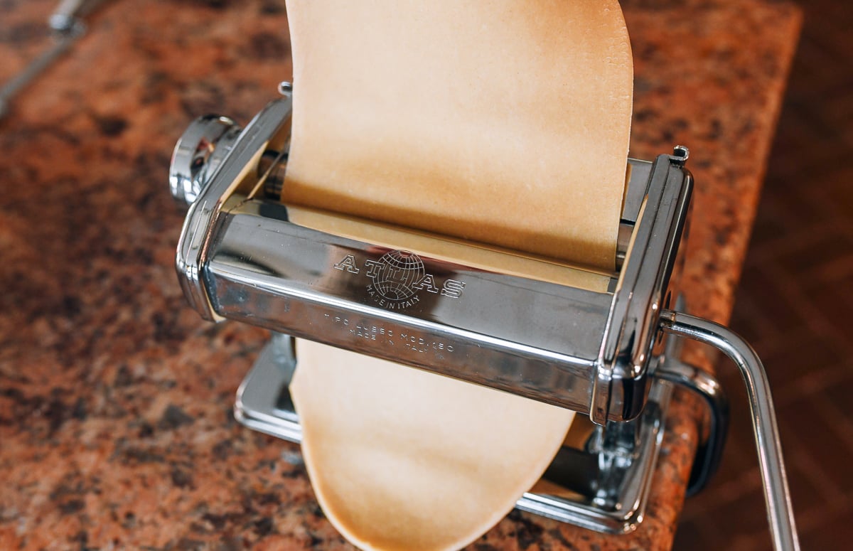 feeding dough through atlas pasta roller