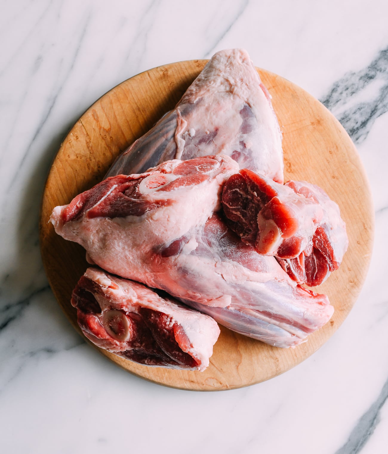 Lamb shanks on cutting board