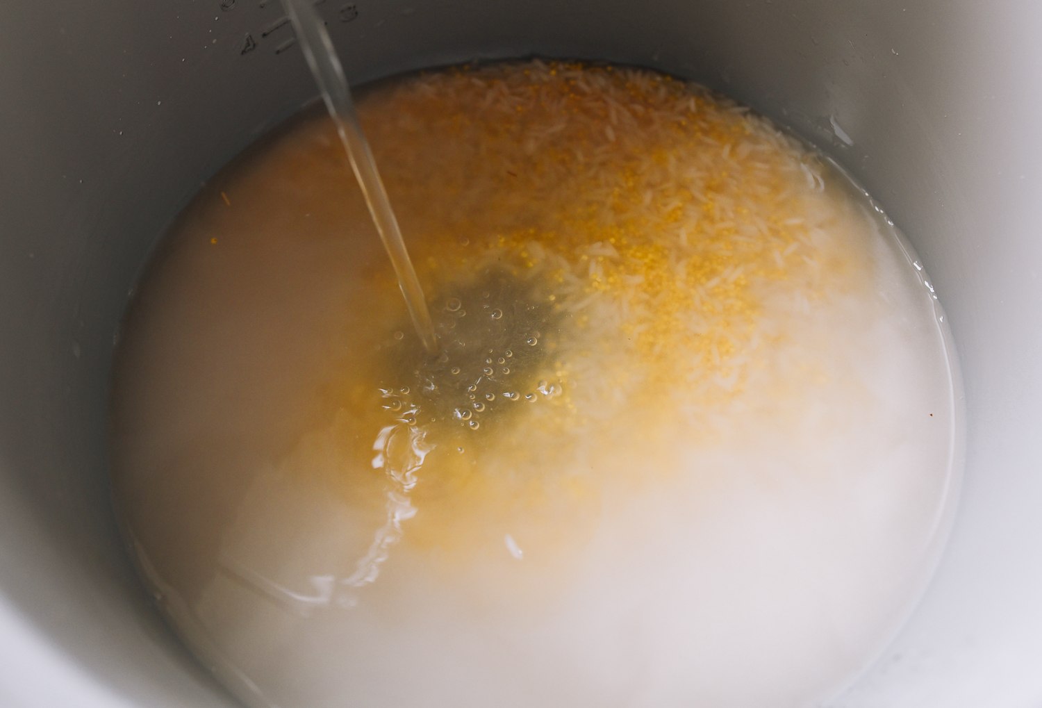 adding water to rice and millet