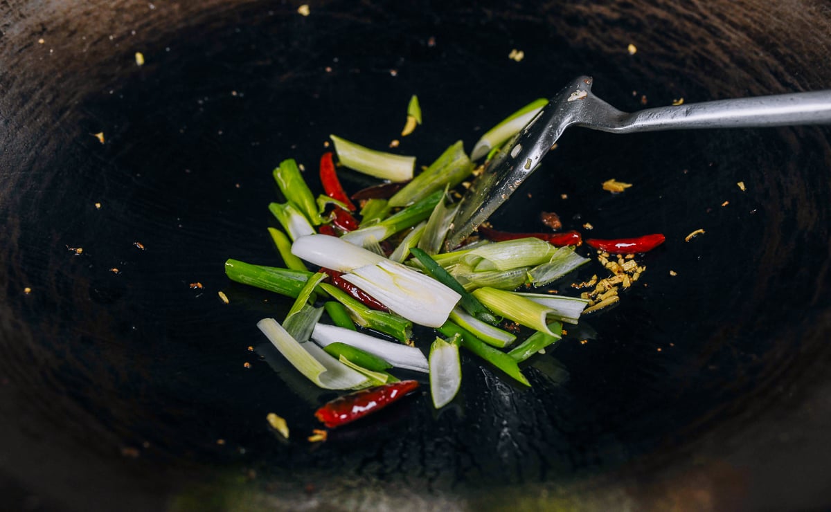 scallion in wok with ginger and chilies