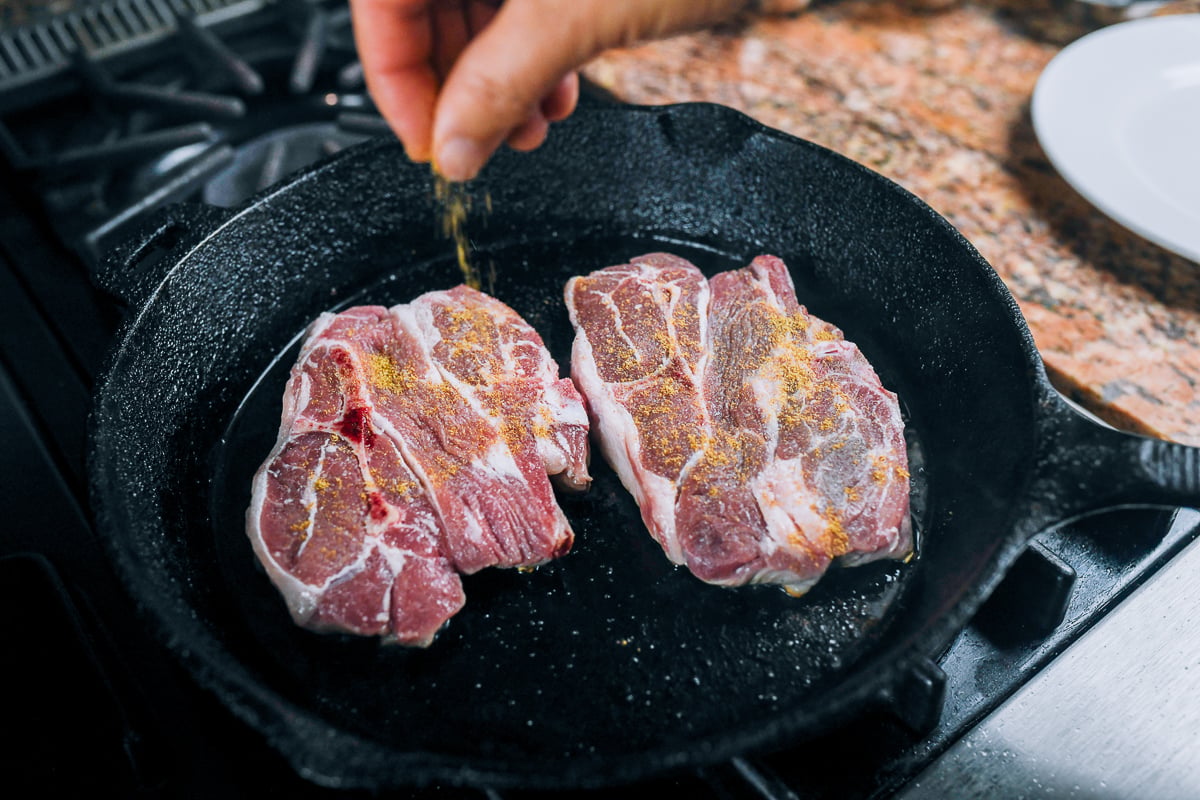 seasoning lamb shoulder chops with cumin and salt