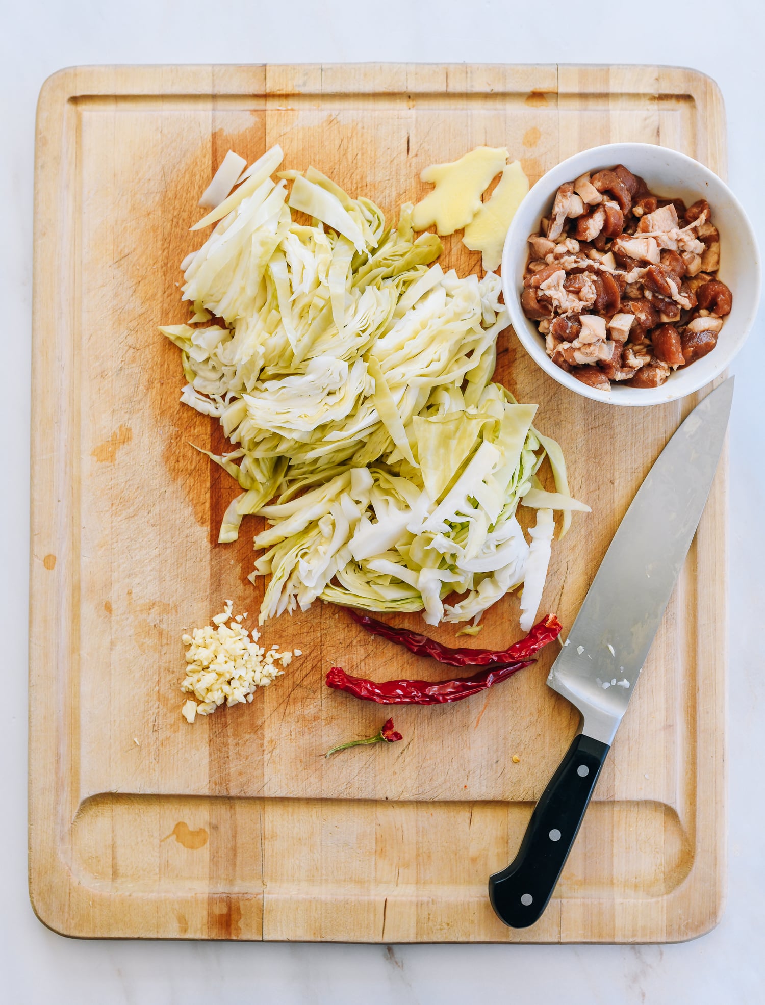 slicing pickled cabbage and pork for stir-fry