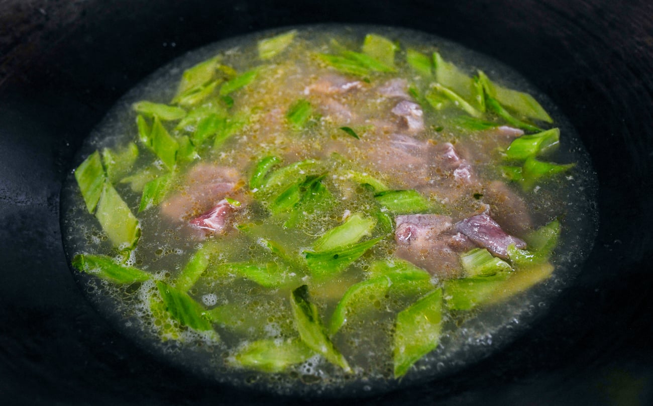 pork slices added to mustard green soup