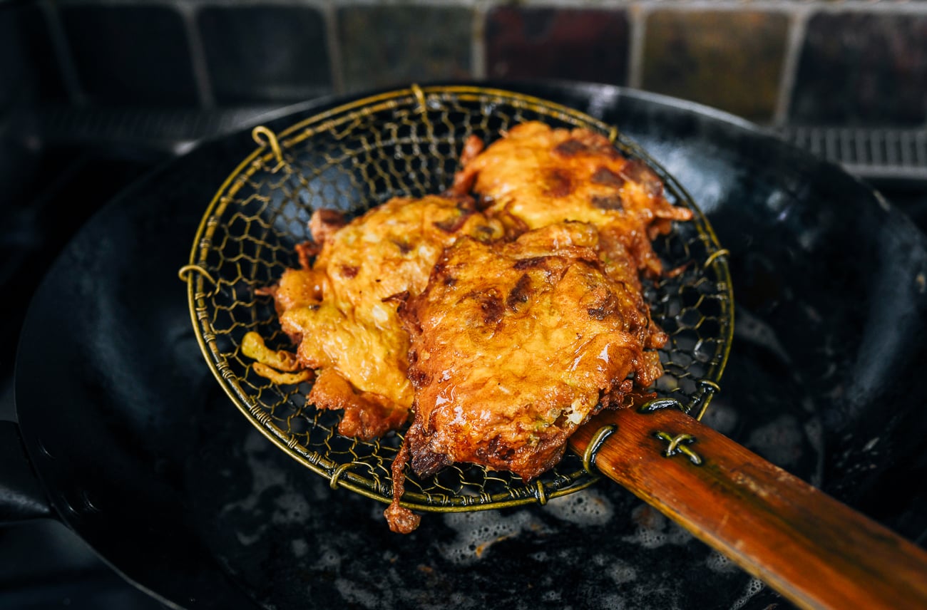 egg foo young patties on spider strainer