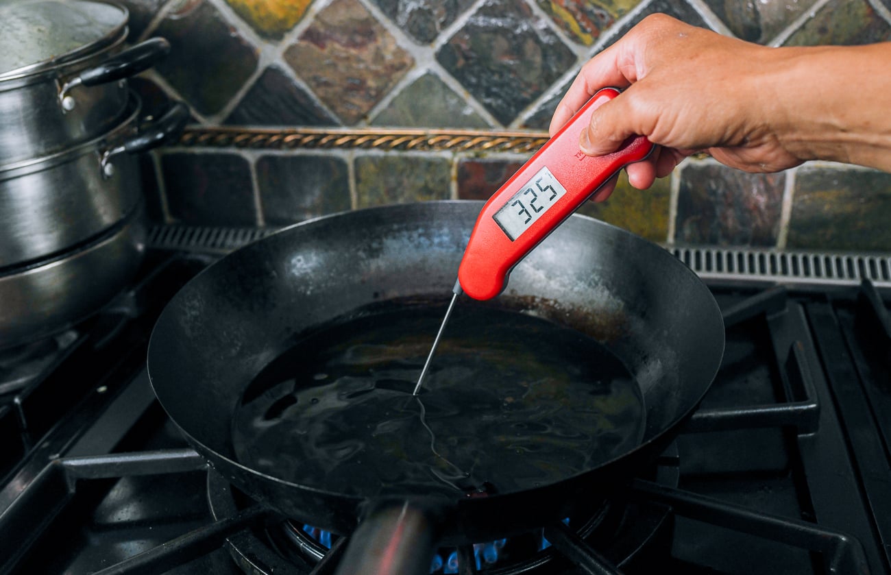 checking oil temperature with thermometer