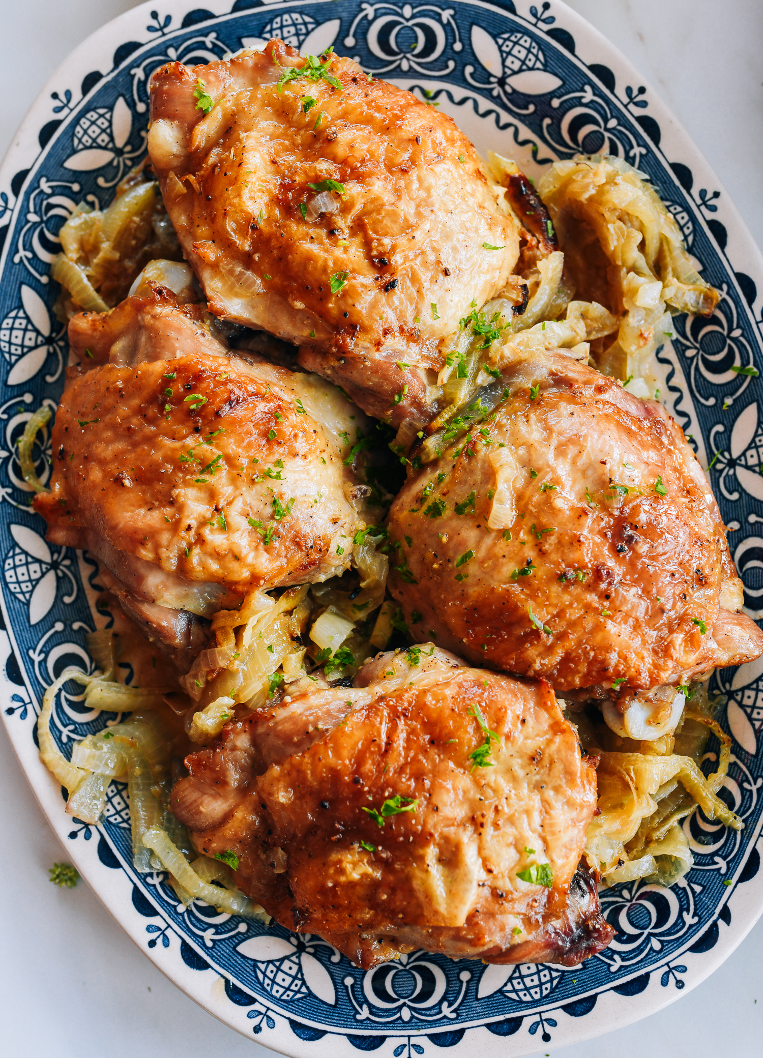 platter of roasted turkey thighs with onions