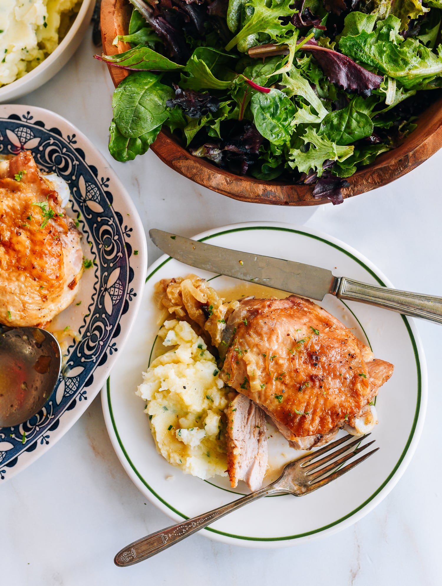 roasted turkey thigh on plate with mashed potatoes and salad