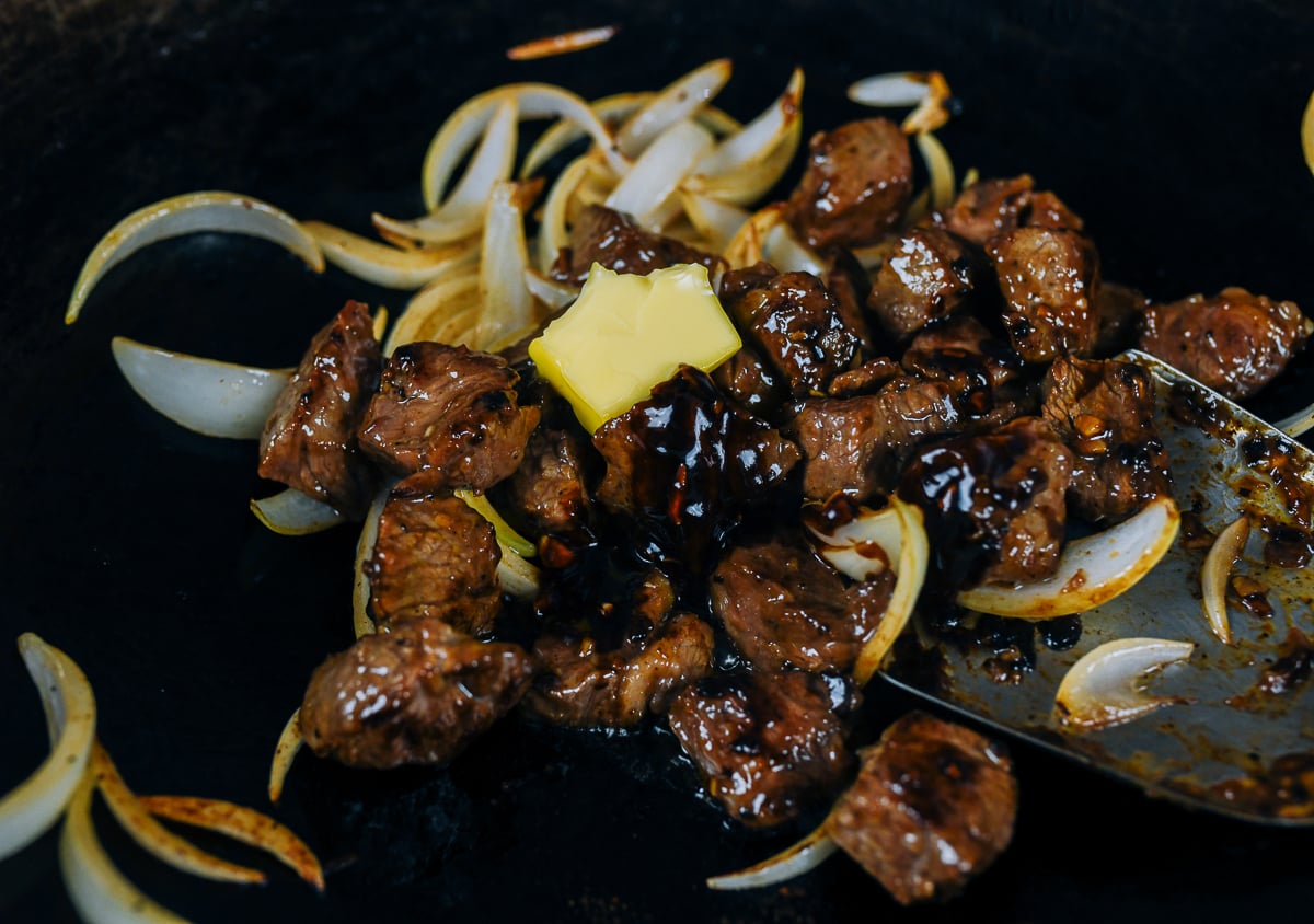 adding butter to vietnamese shaking beef