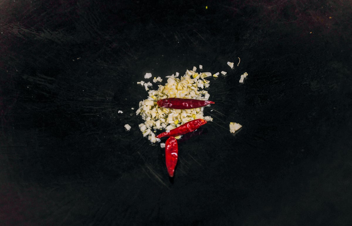 cooking garlic and dried red chilies in wok