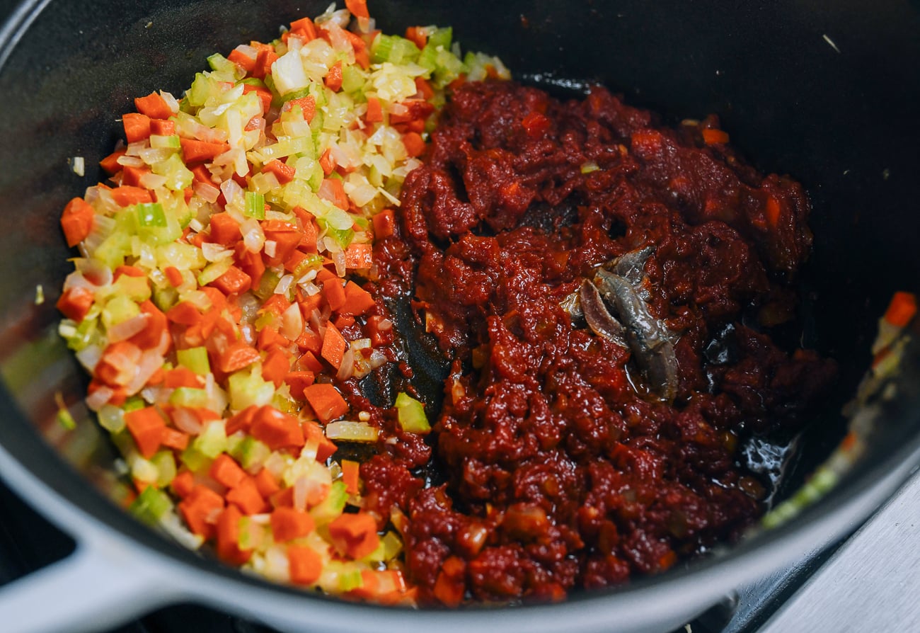 anchovies added to pot with vegetables and tomato paste