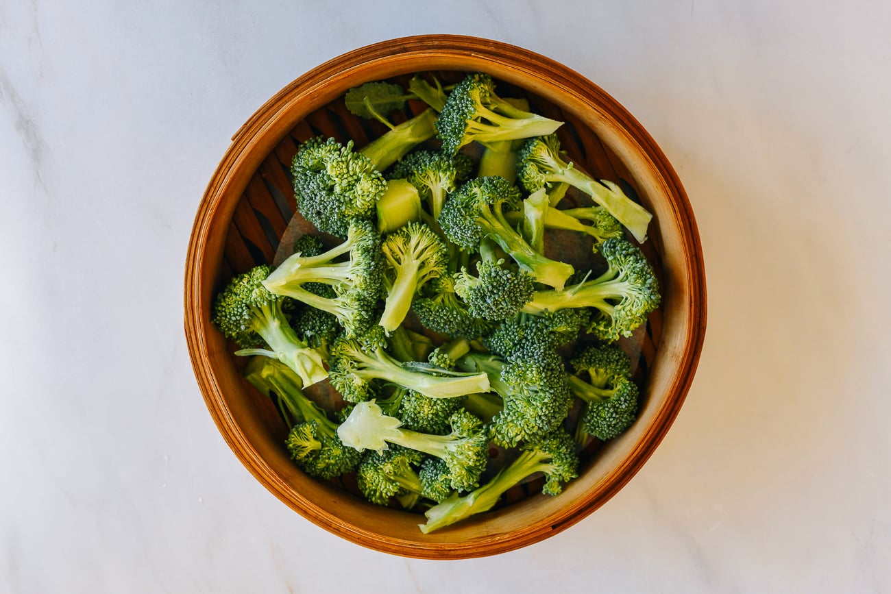 Broccoli florets in bamboo steamer basket