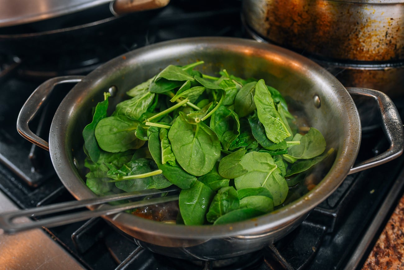 Baby spinach added to soup pot